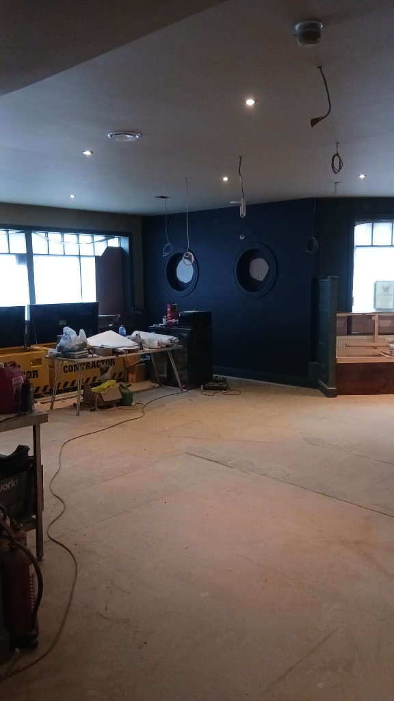 Update 17 September — dark feature wall with circular porthole windows